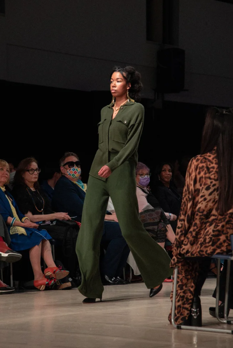 Model wearing a forest green wide leg knit lounge pants with the matching colour button-up shacket.