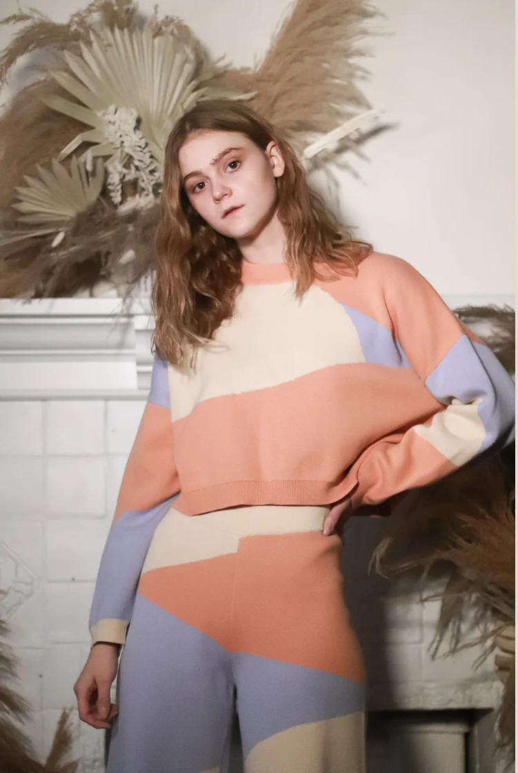 Model wearing a desert inspired print cropped crewneck sweater with the matching wide leg knit lounge pants. 